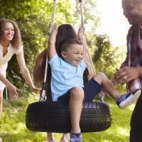 Family on their tire swing outside